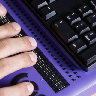 Blind Person Using Computer With Braille Computer Display