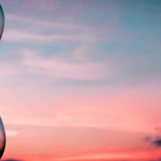 Time Passing At Sunset With Hourglass